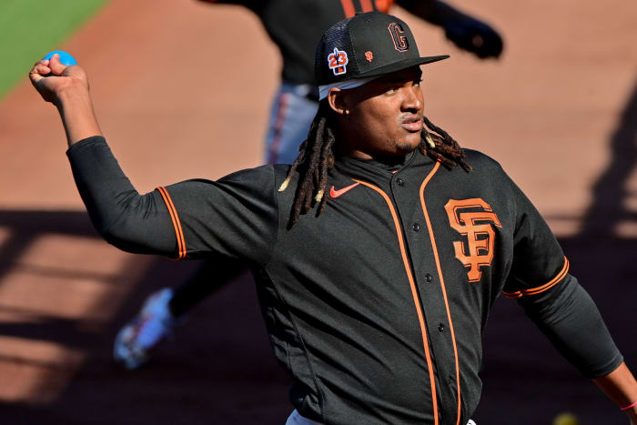 SF Giants pitcher Melvin Adon throws a weighted practice ball during a Spring Training workout at Scottsdale Stadium. (2023)